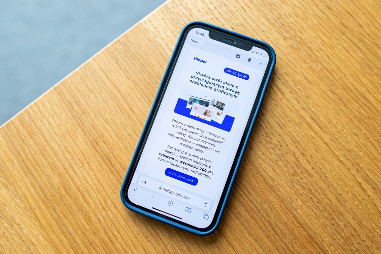 Smartphone exibindo um anúncio de comércio eletrônico sobre uma superfície de madeira