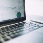 Laptop exibindo um painel de análise com gráficos e indicadores de desempenho.
